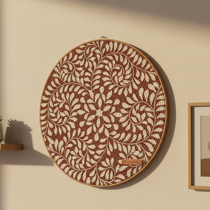 Decorative wall art with floral pattern on a beige wall.